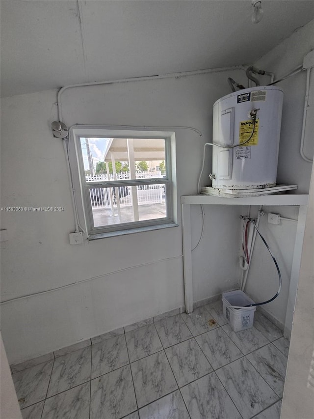 interior space featuring water heater and hookup for a washing machine