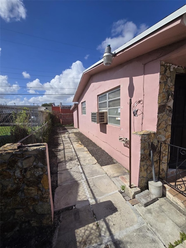 view of home's exterior with a patio and cooling unit