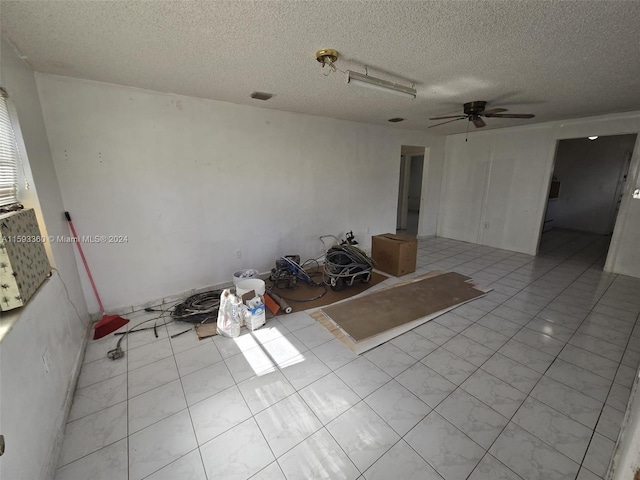 interior space featuring light tile patterned flooring, ceiling fan, and a textured ceiling