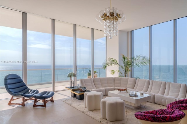 living room with a water view, expansive windows, a chandelier, and tile floors