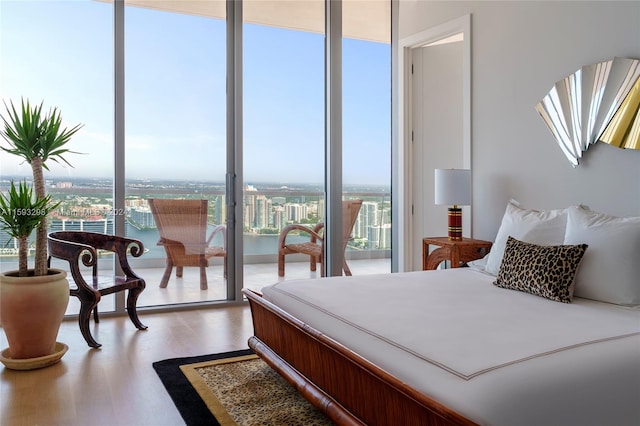 bedroom featuring floor to ceiling windows and wood-type flooring