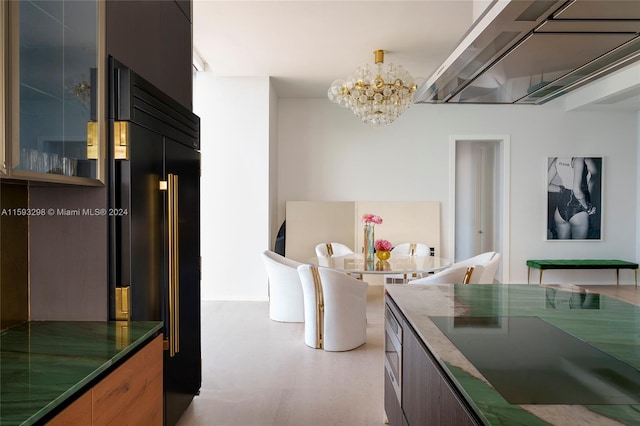 kitchen with a chandelier and built in refrigerator