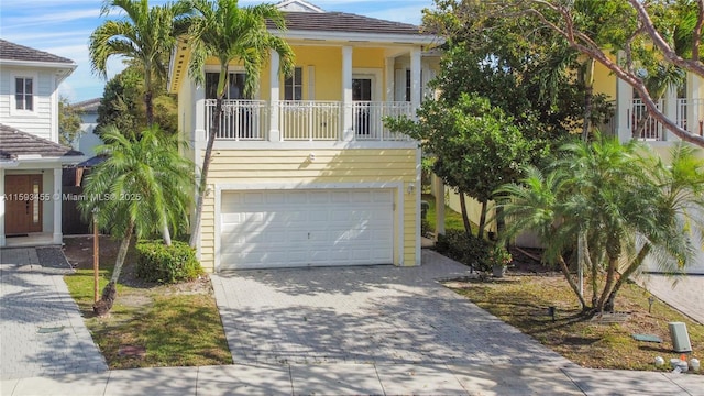 view of front of home with a garage and a balcony