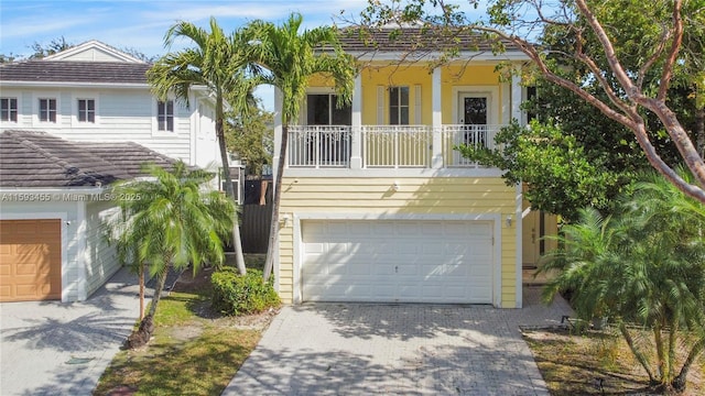 view of front of property featuring a garage and a balcony