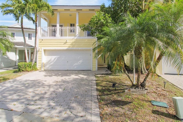 view of front of home with a balcony and a garage