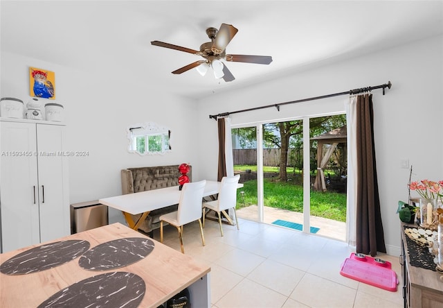 dining area featuring ceiling fan and light tile floors