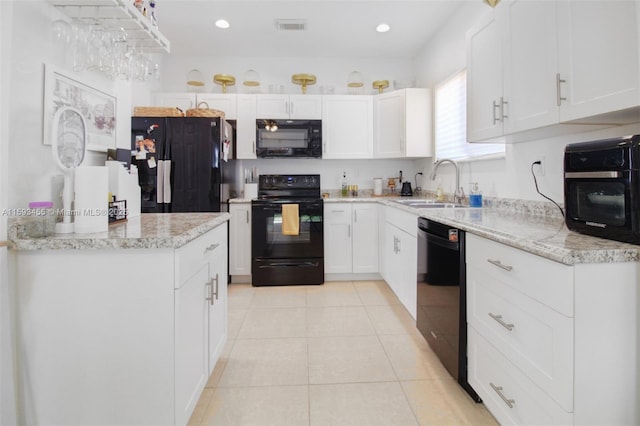 kitchen featuring white cabinetry, sink, black appliances, and light tile patterned flooring