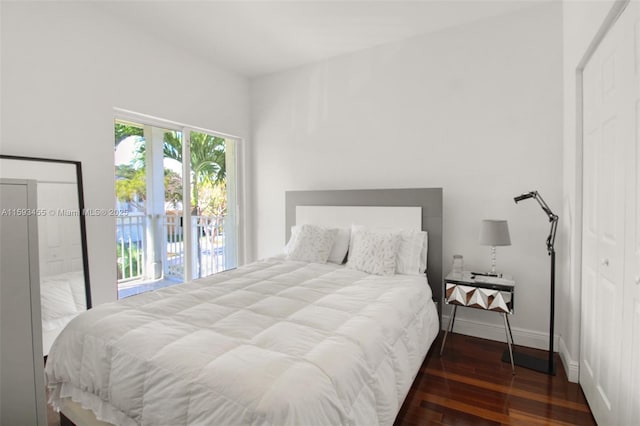 bedroom with dark wood-type flooring and access to exterior