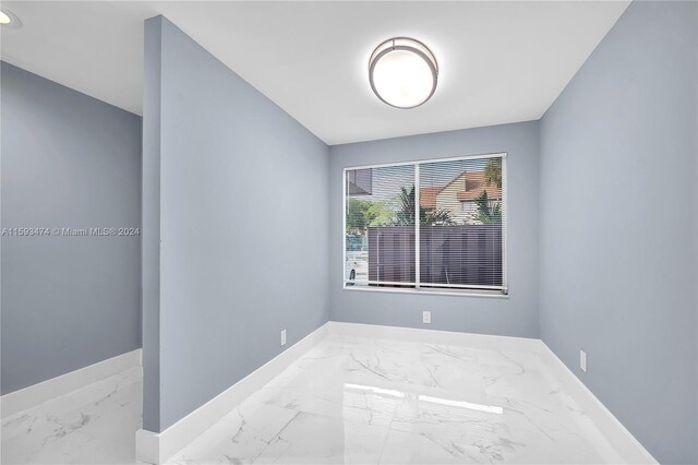 unfurnished room featuring light tile patterned floors