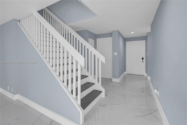 stairway with light tile patterned floors