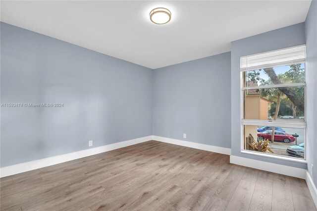 bathroom featuring tile patterned flooring, shower / bath combination with glass door, and toilet