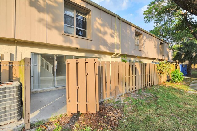 rear view of house featuring central air condition unit