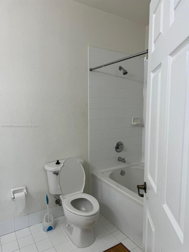 bathroom featuring tile floors, shower / bathtub combination with curtain, and toilet