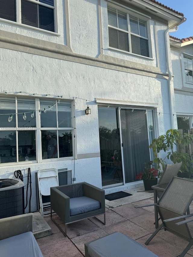 rear view of house with a patio and central air condition unit