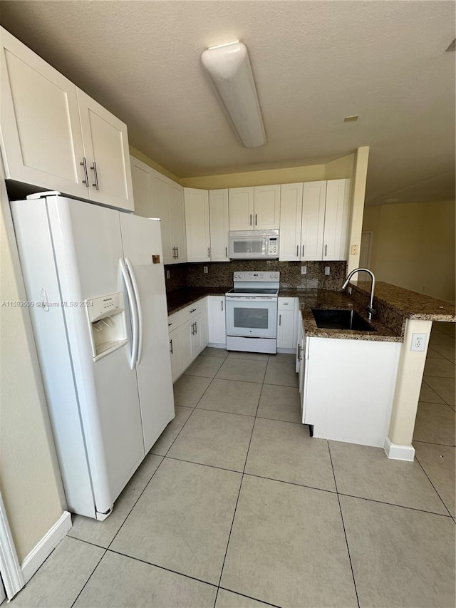 kitchen featuring white cabinets, sink, and white appliances