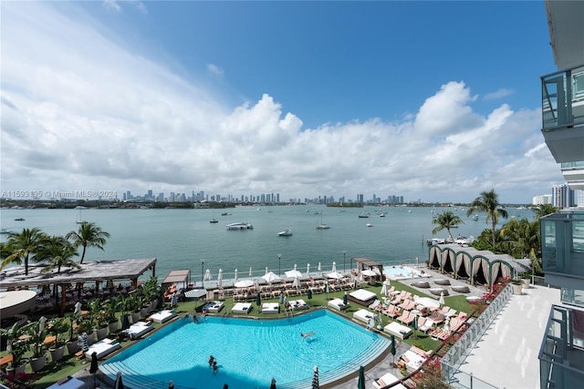 view of swimming pool with a water view