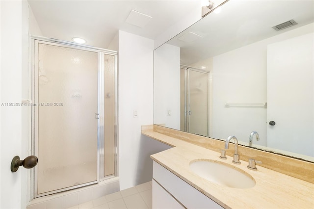 bathroom featuring an enclosed shower, vanity, and tile patterned flooring