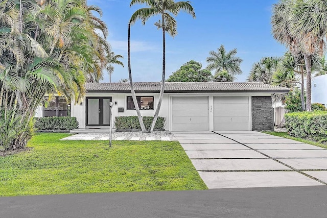 ranch-style house with a garage and a front lawn