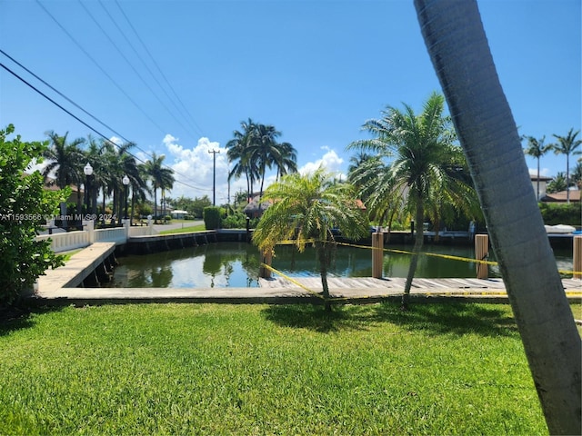 surrounding community featuring a water view and a yard