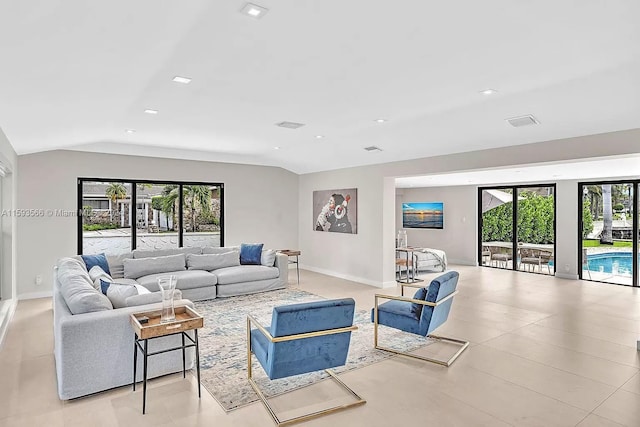 living room with vaulted ceiling and a wealth of natural light