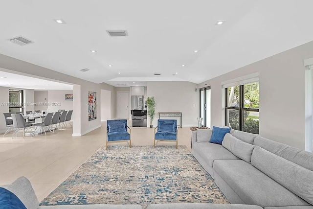 tiled living room with lofted ceiling