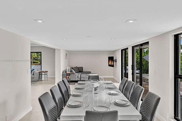 tiled dining space featuring a wealth of natural light