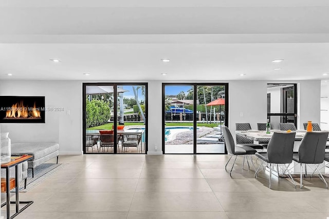 tiled dining space with a wealth of natural light and a wall of windows