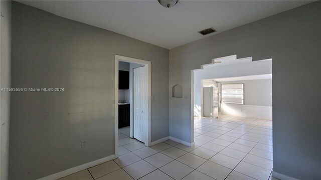 hall with light tile patterned floors