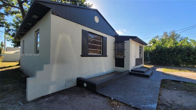 view of side of property featuring a patio area