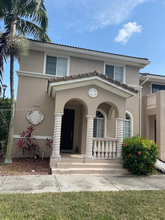 view of front of home with covered porch and a balcony