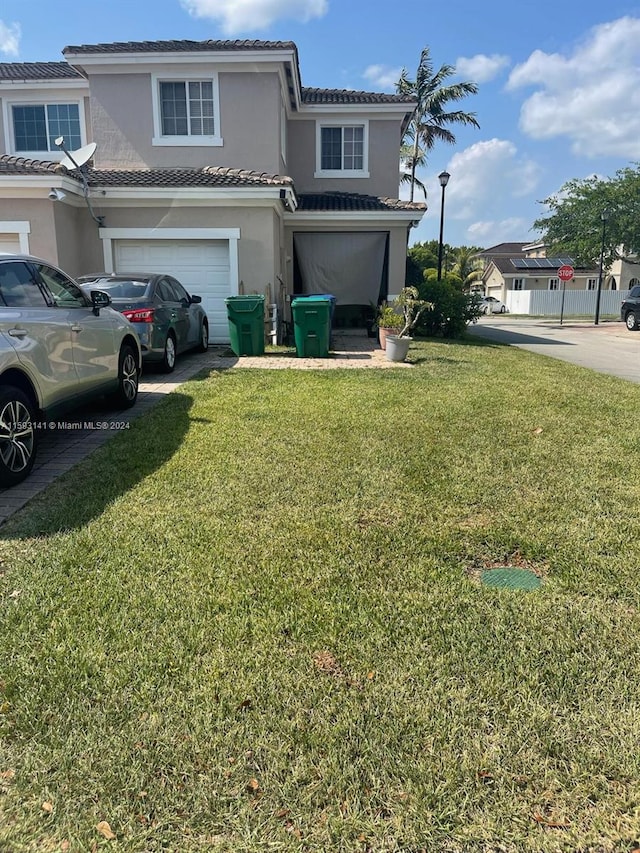 view of front of house with a garage and a front lawn