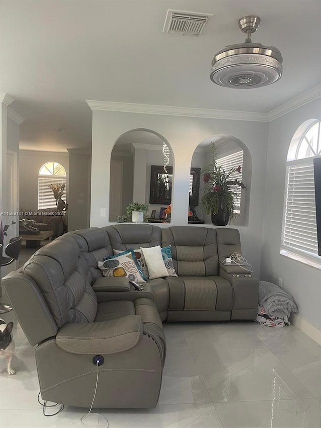 living room with tile flooring, plenty of natural light, and crown molding