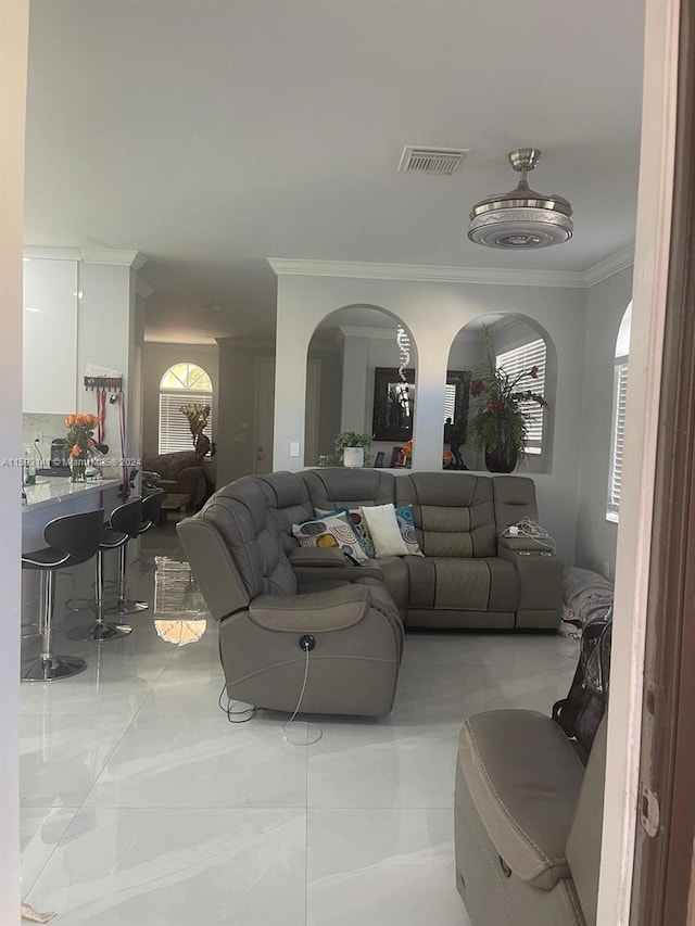 living room featuring crown molding and light tile floors