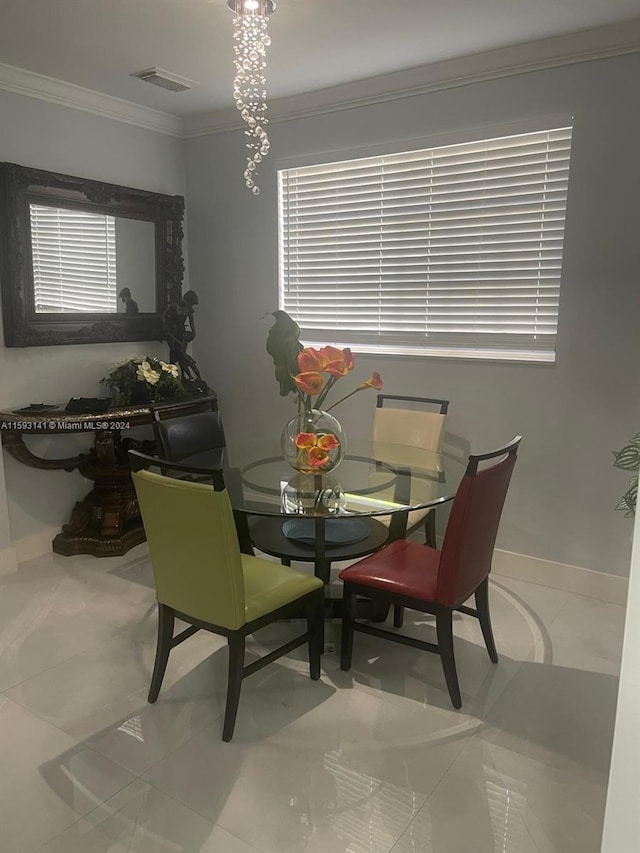 dining area with tile flooring, plenty of natural light, and ornamental molding