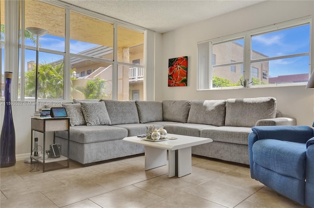 living room featuring a textured ceiling and light tile floors