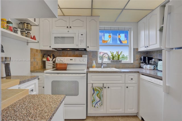 kitchen featuring white cabinetry, white appliances, and tasteful backsplash