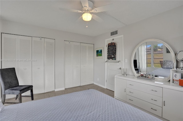 bedroom featuring multiple closets and ceiling fan