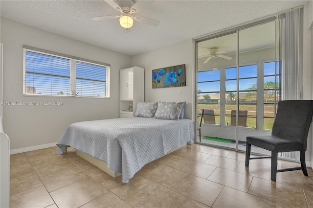 bedroom with a textured ceiling, ceiling fan, and light tile floors