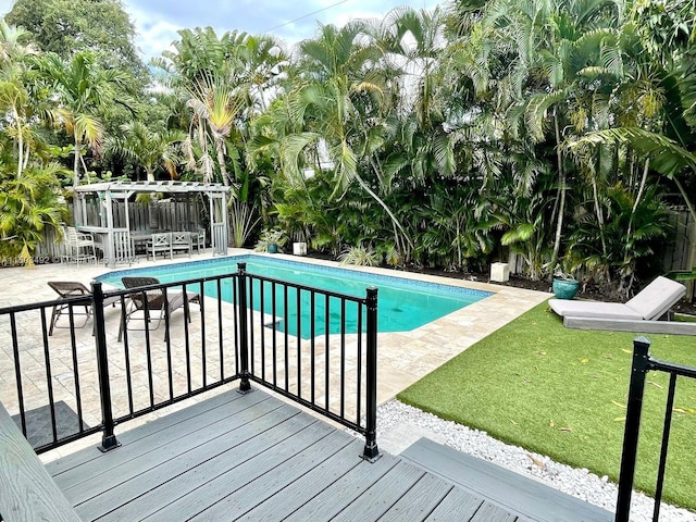 view of swimming pool with a yard and a patio area