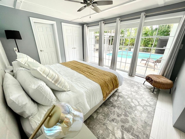 bedroom featuring a closet, ceiling fan, access to outside, and multiple windows