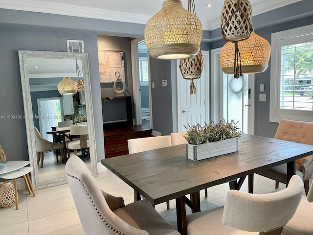 dining area with light hardwood / wood-style flooring and crown molding