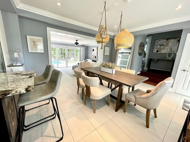 tiled dining space featuring french doors, ornamental molding, and ceiling fan