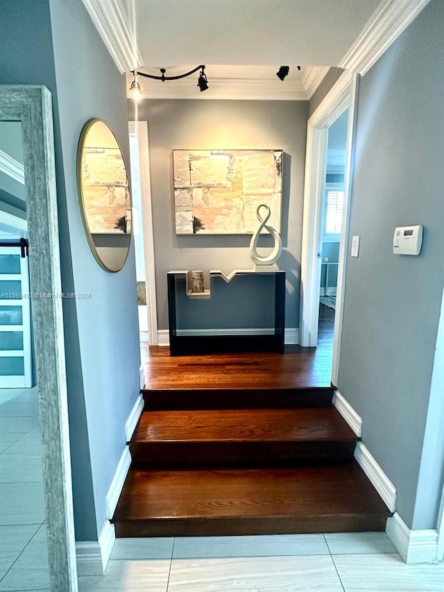 stairway featuring ornamental molding and hardwood / wood-style floors