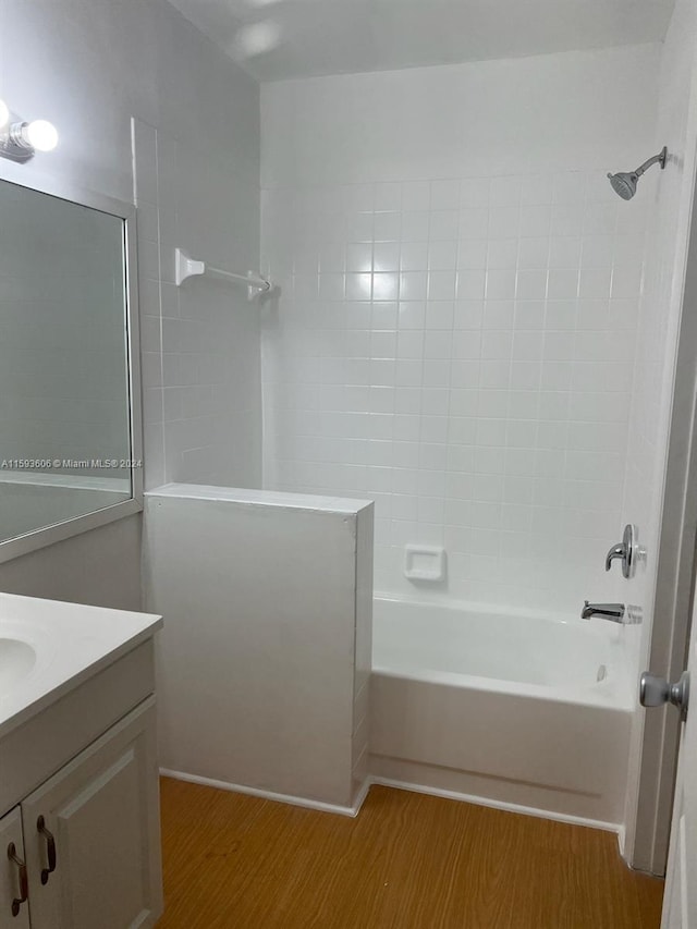 bathroom with vanity, wood-type flooring, and shower / tub combination