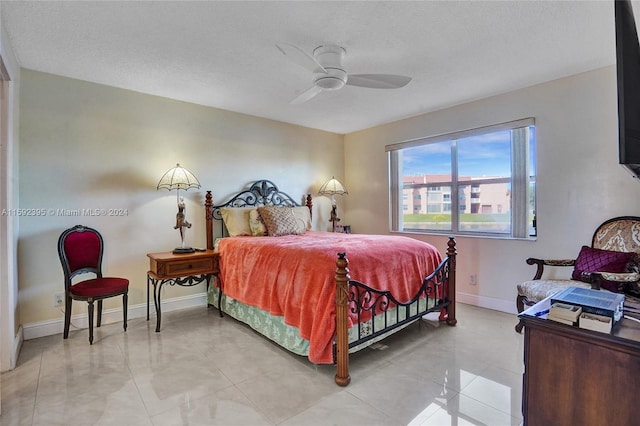 bedroom featuring tile floors, a textured ceiling, and ceiling fan