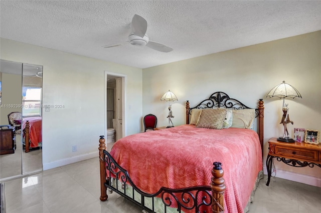 tiled bedroom with a textured ceiling, a closet, ensuite bathroom, and ceiling fan