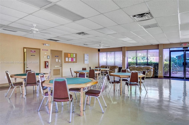 dining area with a paneled ceiling and ceiling fan