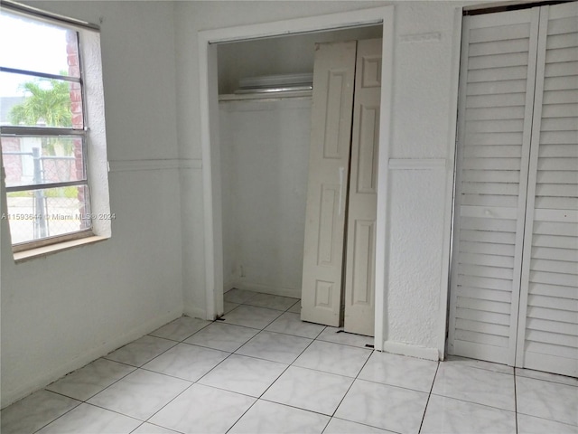 unfurnished bedroom featuring light tile patterned flooring