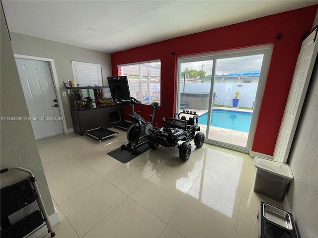 workout room featuring light tile patterned flooring