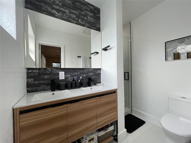 bathroom featuring vanity, toilet, tile patterned flooring, and backsplash